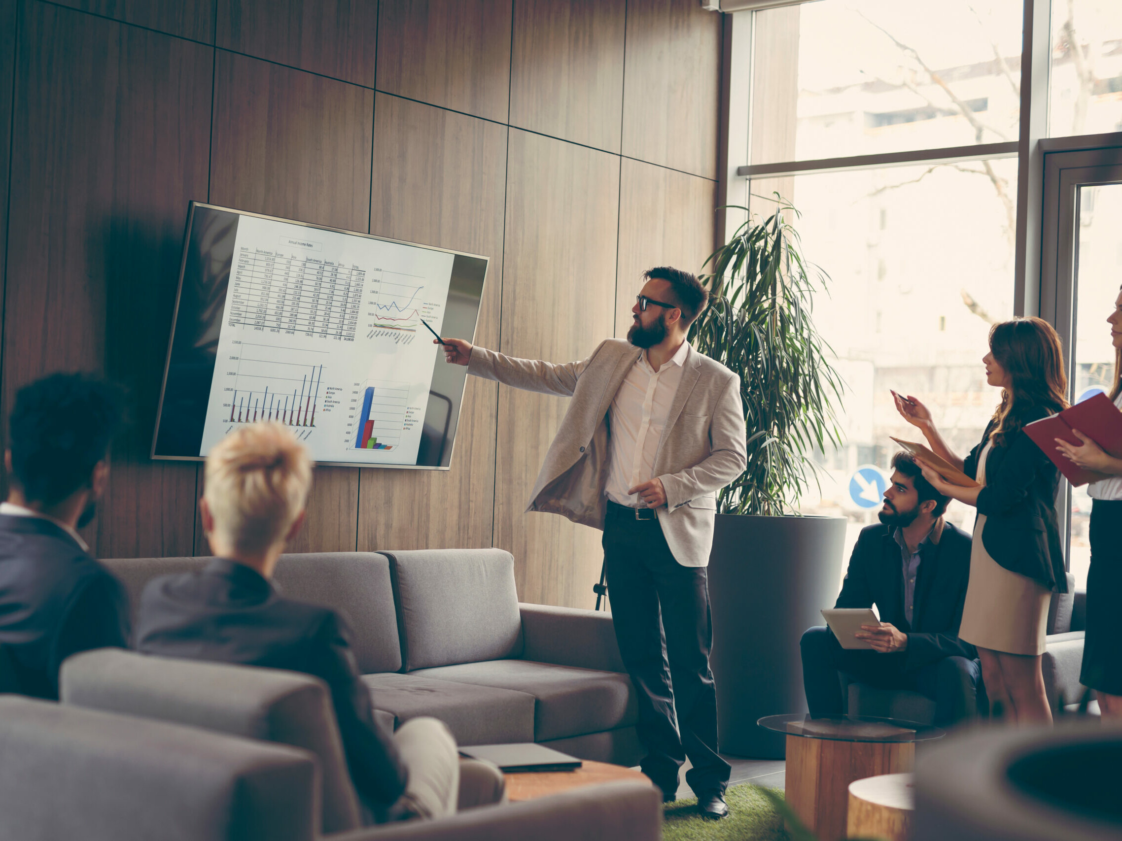 Sales team sits in a presentation to discuss improving processes with RPA.